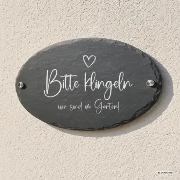 Ovales Türschild mit Spruch „Eigene Worte“ aus Schiefer, an der Hauswand mit Edelstahl-Abstandshaltern
